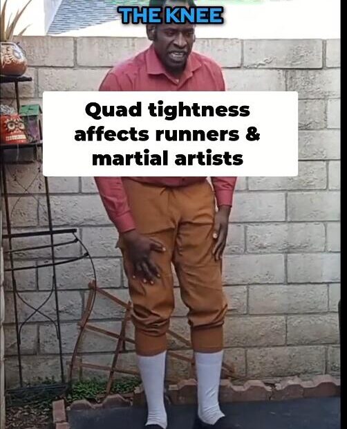 Instructor Carlo showing how to stretch the quads